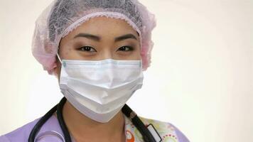 Young asian doctor woman posing on a white background in the studio video