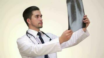 Respectable male doctor examines an x-ray video