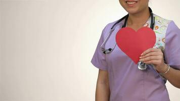 Asian girl nurses holding a paper heart video