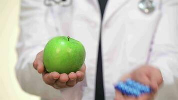 Nurse or doctor showing pharmaceutical and an apple video