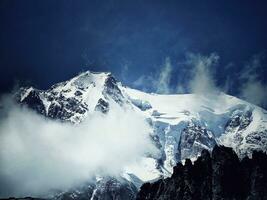 the mountain range of mont blanc covered with snow at punta hellbronner in courmayeur in the aosta valley in july 2023 photo