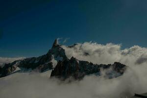 the mountain range of mont blanc covered with snow at punta hellbronner in courmayeur in the aosta valley in july 2023 photo