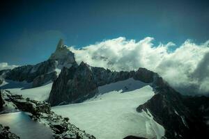 Mont Blanc mountain range under the snow in Valle d'Aosta in Courmayeur, in the summer of 2023 photo