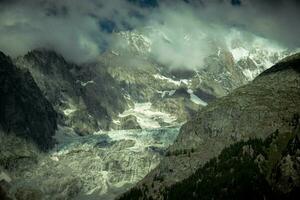 the mountain range of mont blanc covered with snow at punta hellbronner in courmayeur in the aosta valley in july 2023 photo