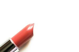 Coral lipstick isolated on white. The concept of fashion and beauty industry. Close up. - Image photo