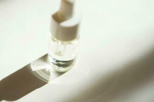 Cosmetic or medical glass bottle with pipette. Skin care concept. Natural hard light, deep shadows. - Image photo