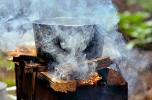 Preparing food on campfire photo