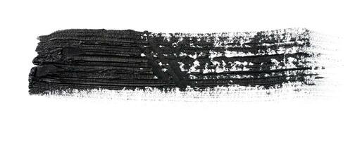 Black paint stroke with bristle brush, swatch isolated on white background photo