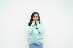 Portrait Indonesian beautiful woman wearing light blue sweater with surprised gesture isolated on white background photo