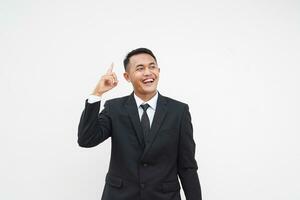Portrait Young Asian businessman get a idea, smart, finger pointing up, isolated on white background photo