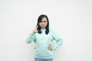 Portrait Indonesian beautiful woman wearing light blue sweater angry gesture isolated on white background photo