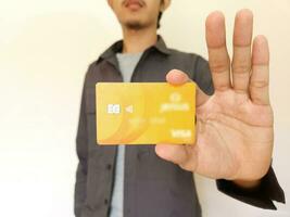 Man Holding and showing an orange credit card photo