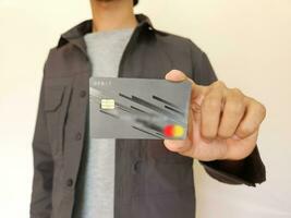 Young man showing credit card photo