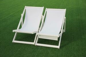 white beach deck canvas chair on the green grass photo
