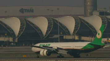 BANGKOK, THAILAND MARCH 01, 2023 - Widebody Boeing 777 of EVA Air braking after landing at Suvarnabhumi Airport, side view. Aircraft arriving. EVA Airways Taiwanese international airline video