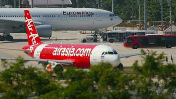 PHUKET, THAILAND NOVEMBER 26, 2016 - Shot, AirAsia passenger plane taxiing on the runway. Asian Airlines Airbus A320 ready to take off at Phuket Airport. Tourism and travel concept video