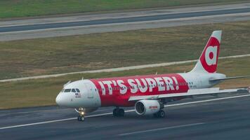 PHUKET, THAILAND FEBRUARY 03, 2023 - Footage of Airbus A320, 9MAHL AirAsia with Super App Livery taxiing at Phuket airport. Asian low cost airline. Airfield. Tourism and travel concept video