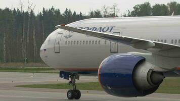 MOSCOW, RUSSIAN FEDERATION JULY 29, 2021 - Boeing 777 of Aeroflot taxiing at Sheremetyevo airport. Plane on taxiway, side view. Passenger airliner Russian Airlines on the airfield video