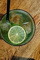 frozen glass of mojito, an alcoholic drink based on rum and lime and typically summer soda, in a bar on the Ligurian Riviera photo