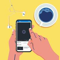 Hand holding smartphone with video player while sitting in modern hipster cafe at the table with cup of coffee and earphone vector