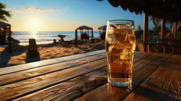 Delicious cold iced tea in a glass on a table on the beach in summer photo