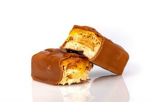 Broken chocolate bar on white background photo