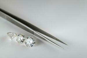 Diamonds and Jewelry Tweezers. Jewelry Design Background photo