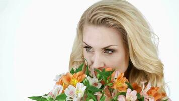 Portrait of blonde is smelling bouquet video