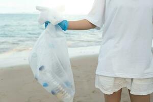 Save ocean. Volunteer pick up trash garbage at the beach and plastic bottles are difficult decompose prevent harm aquatic life. Earth, Environment, Greening planet, reduce global warming, Save world photo