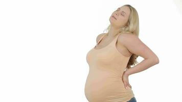 Pregnant blonde stretching her back isolated over white background video