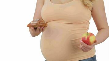 Pregnant woman choosing between apple and cake video