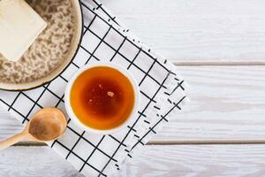 Fragrant melted brown butter for sauce in a bowl on the table top view photo