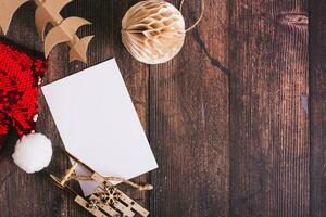 Wish list for santa claus, hat, cardboard tree and homemade ball on the table top view photo