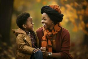 Portrait of happy african american mother and son in garden. motherhood, childhood, togetherness, autumn and leisure, AI Generated photo