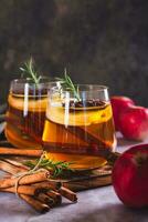 Apple margarita with spices and rosemary in glasses on the table vertical view photo