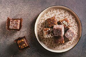 Close up of healthy candies made from figs, dates, nuts, coconut and sesame seeds top view photo