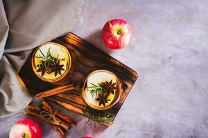 Apple margarita with spices and rosemary in glasses on the table top view photo
