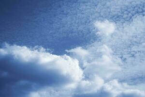 Blurred background. Blue sky and white fluffy clouds. photo