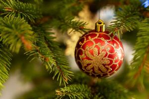 Christmas tree toys on the branches of the Christmas tree. red Christmas ball photo