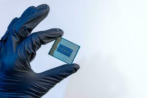 computer processor in a gloved hand on a white background photo