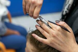 boy in a beauty salon makes a stylish hairstyle photo