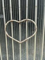 metal heart on the fence. love. metal background photo