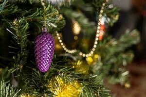 Miniature Christmas toy - a fir cone on the branches of a Christmas tree photo