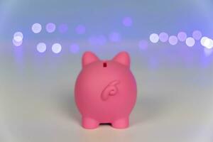 Rear view of the ass of a Pink piggy bank on a New Year's Christmas background photo