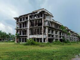 old building with broken windows in abandoned city. photo