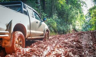 Muddy off-road vehicles, off road trip on mountain road sunset beautiful nature photo