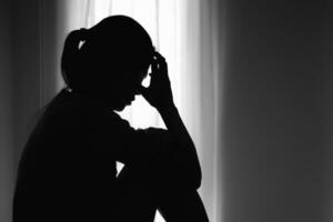 Asian woman sitting on the house area Feeling sad, tired and worried about depression, mental health problems and heartbreaking concept. photo