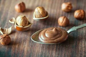 Spoon of chocolate paste with hazelnuts photo