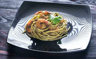 Pasta with shrimps and pesto sauce photo