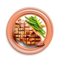 grilled pork steak with vegetables and sauce photo